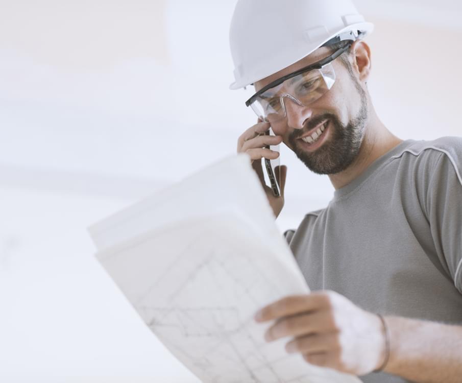 Builder Looking At The Plans He Made